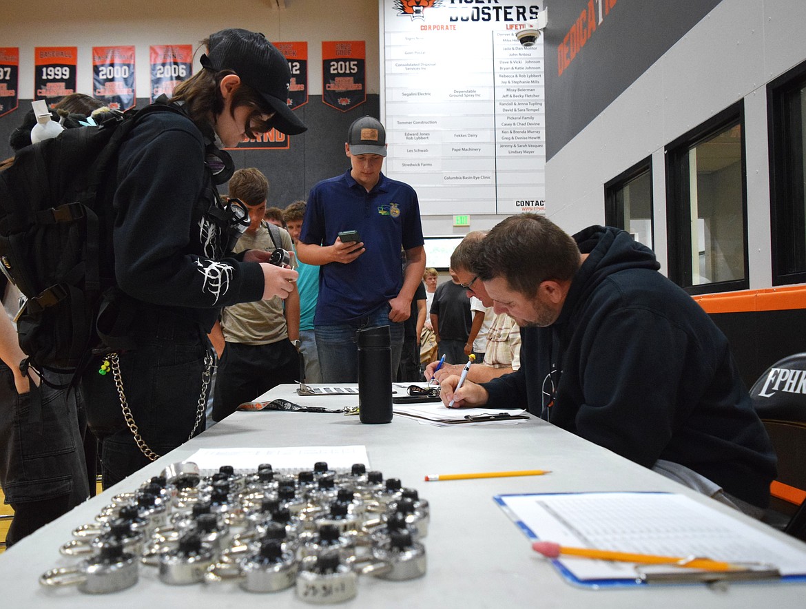 Ephrata High School students receive their combination locks for their gym lockers Thursday during their second period class.