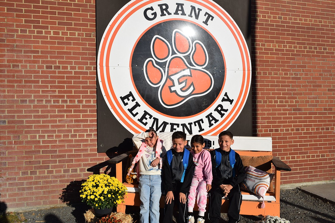 Groff Elementary School students pose on the bench for their parents to take a picture on the first day back to school.