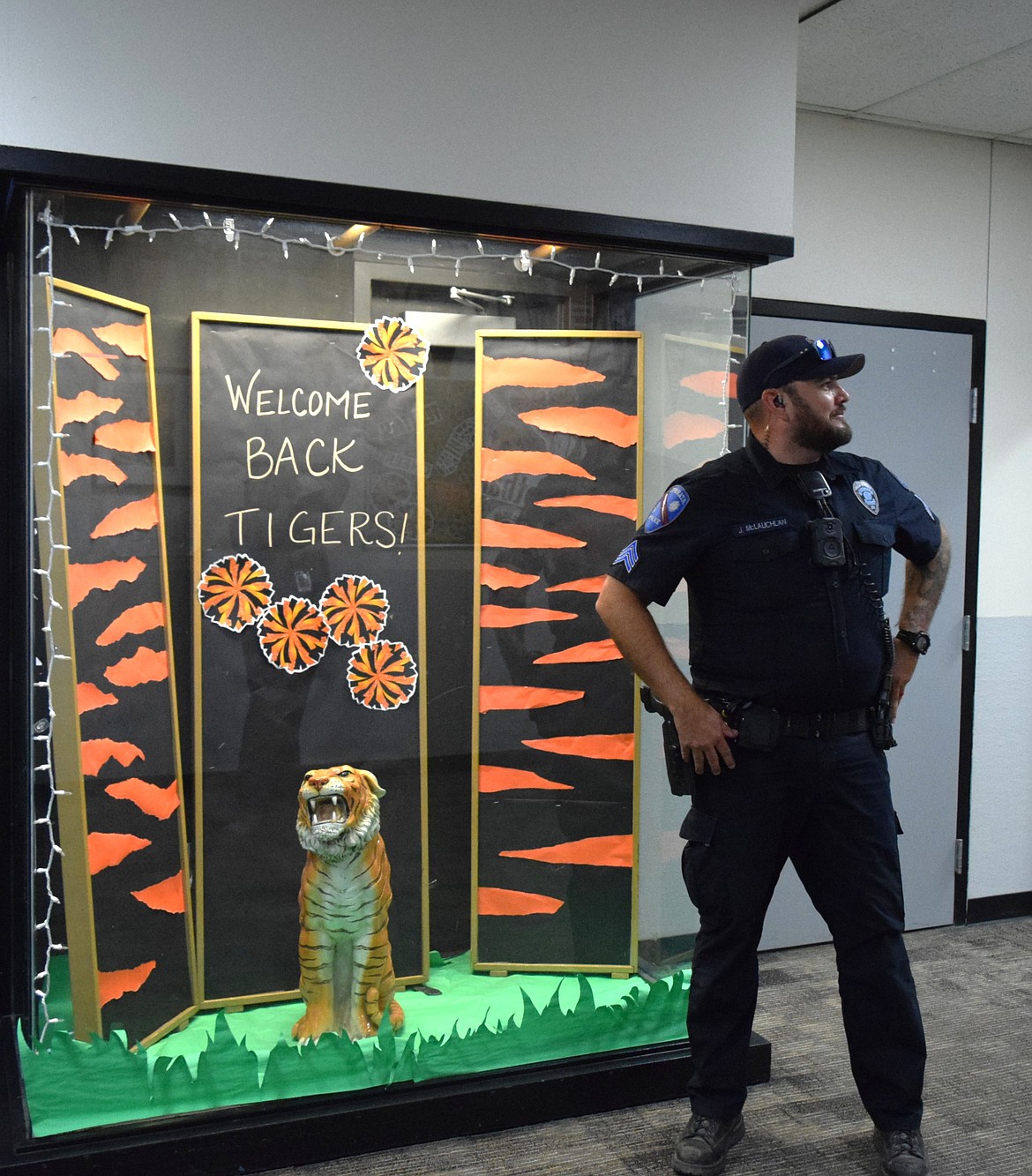 Ephrata Police Dept. Sergeant Jack McLauchlan poses next to the tiger on the first day of school.
