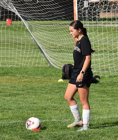 Brooklyn Hillman, a senior for the Huskies, prepares to pass the ball to her teammate during early season practice.