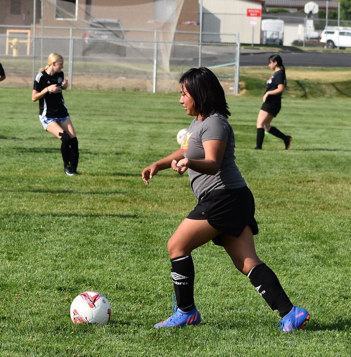 Othello’s Michelle Herrera chases after the ball in the late summer heat during practice ahead of the season.