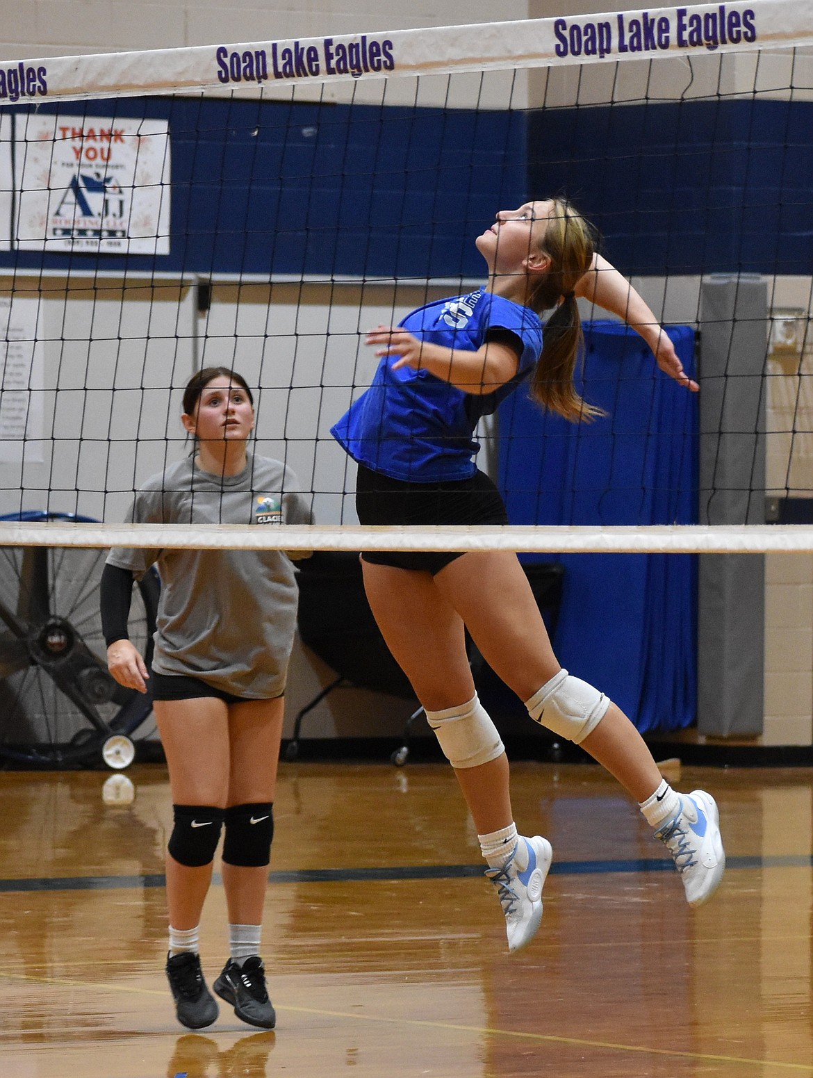 Marina Zubritzkiy, a sophomore from the Eagles leaps up to spike the ball over the net at practice.