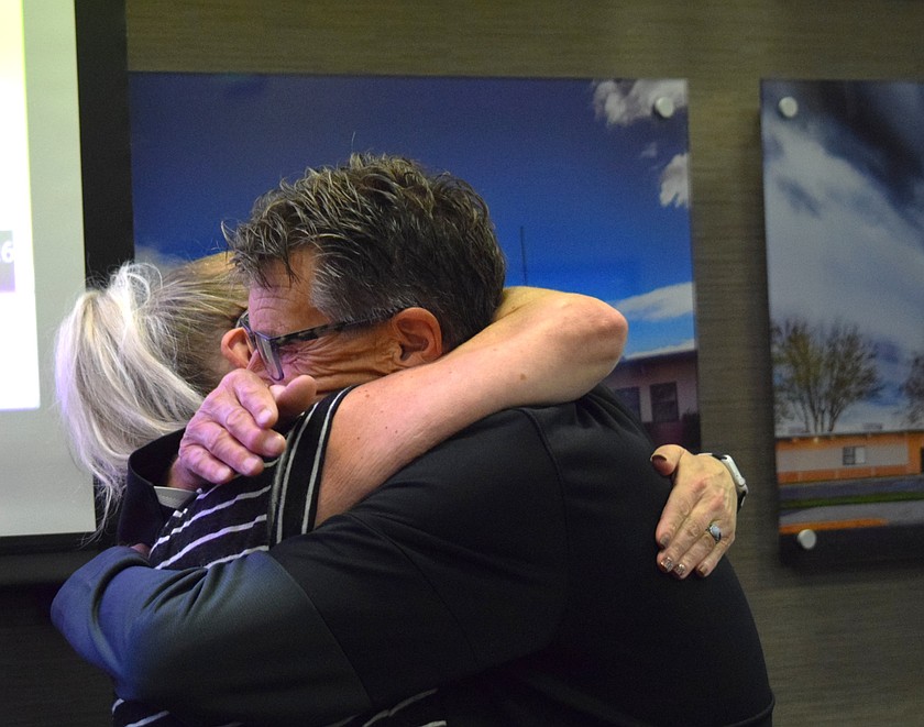 Moses Lake School Board member Amy Breitenstein hugs board president Paul Hill following his announcement he will be resigning from the board effective upon the adjournment of the Sept. 17 meeting. Hill began serving on the board in 2021.