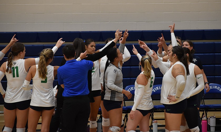 The Vikings huddle together for a peptalk during a timeout Friday afternoon against Highline.