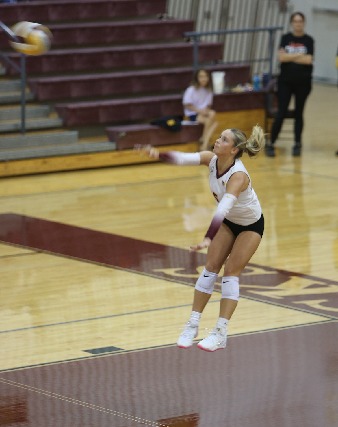Maddy Witwer (5) serves the ball against Hanford, Thursday.