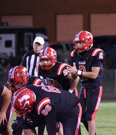 Huskies quarterback Noah Ozuna (2) prepares to snap the ball during the home opener against Ellensburg.