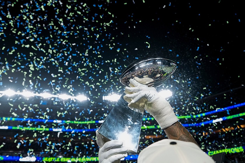 FILE - A member of the Seattle Seahawks celebrates with the Lombardi Trophy after defeating the New England Patriots in the NFL Super Bowl 60 football game, Feb. 8, 2026, in Santa Clara, Calif.