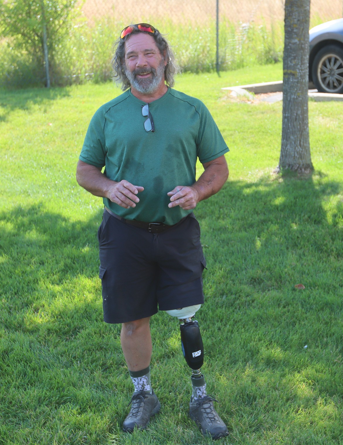 Tom Carroll smiles as he tests out a microprocessor knee behind the Kootenai Prosthetics and Orthotics building.