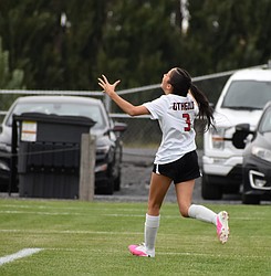 Bella Garza from the Huskies rushes away from the net in celebration after scoring the first goal of the game against the Tigers.