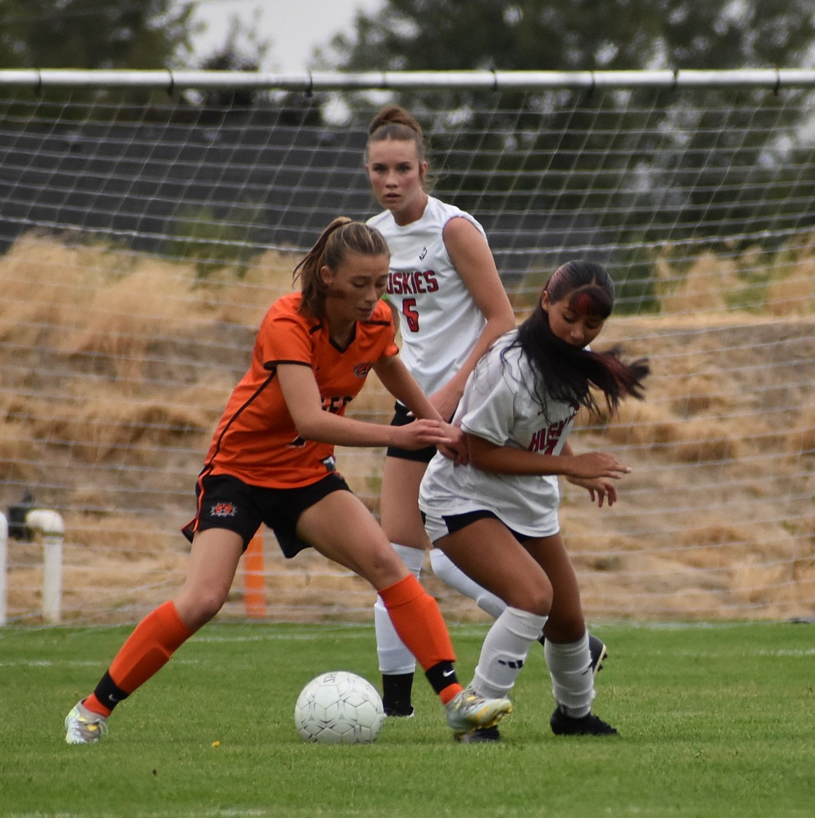 Tigers freshman Ellie Molitor and Huskies sophomore Elizabeth Garcia-Herrera battle for possession of the ball during Thursday’s matchup.