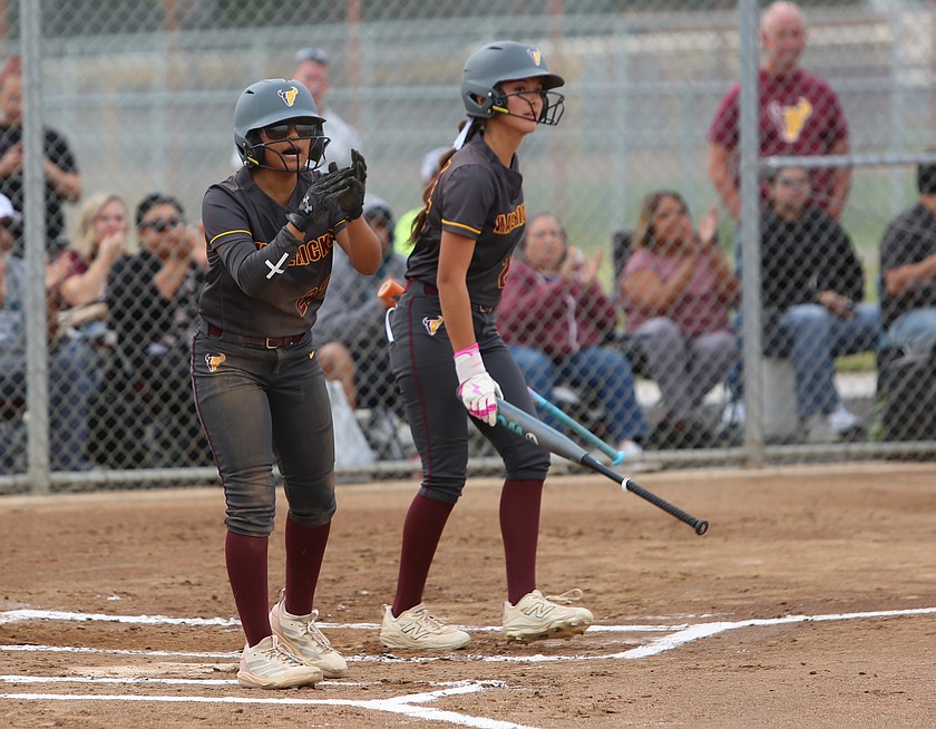 After scoring a run, Mya Martinez (22) encourages her teammate who made got to first and recorded the RBI. The Moses Lake Mavericks are 2-0 after sweeping Sageview at home.