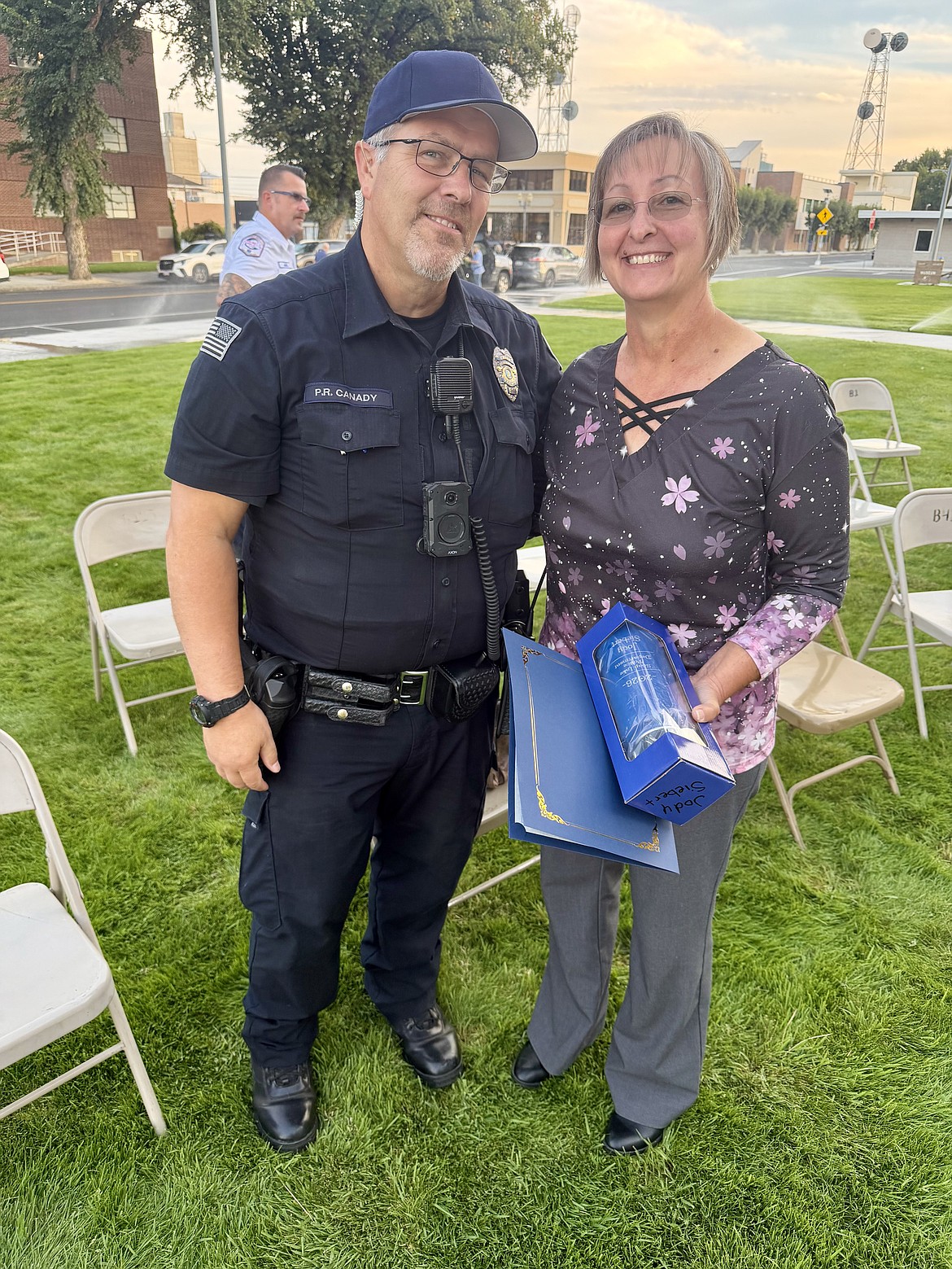 Soap Lake Police Chief Patrick Canady poses with administrative assistant Jody Siebert after Siebert was recognized as the Soap Lake Police Department's First Responder of the Year during the Patriot Day ceremony Friday at the Grant County Courthouse in Ephrata. Siebert was honored for her dedication to the department and the many behind-the-scenes responsibilities that support public safety.