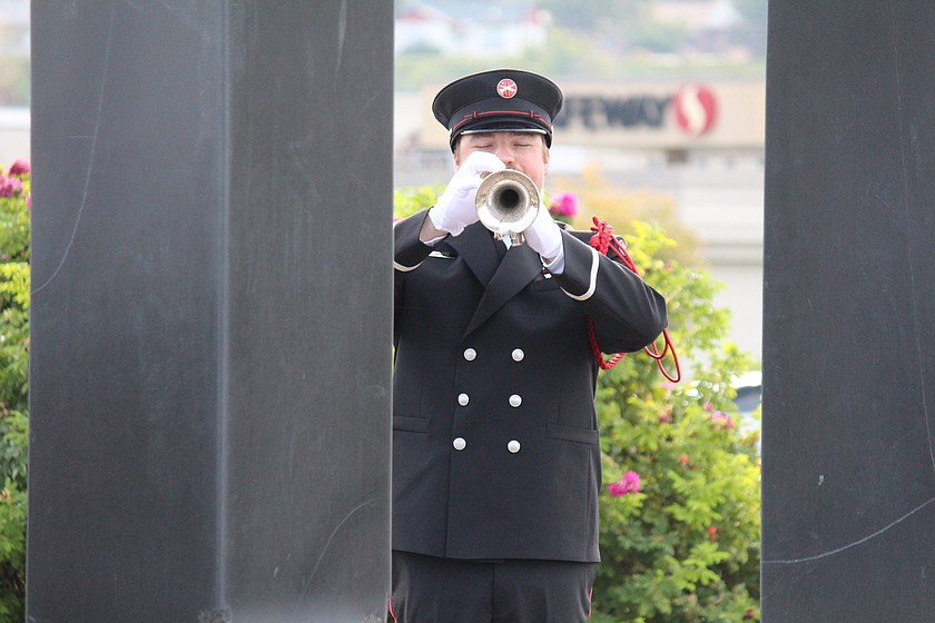 Framed by the pillars of the 9/11 Memorial in Moses Lake's Civic Park, Joshua Oord of the Moses Lake Fire Department plays "Taps."