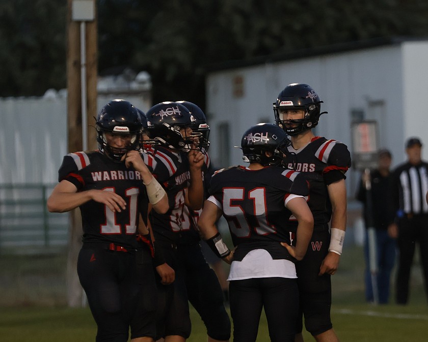 Max Grindy (most right) and the Warriors offense huddles together during their game against Chewelah earlier this season.