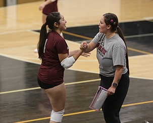 Wahluke Warriors head coach Monica Cortez (right) hypes up Dennys Perez Mendoza (4) during their game against the Royal Knights.