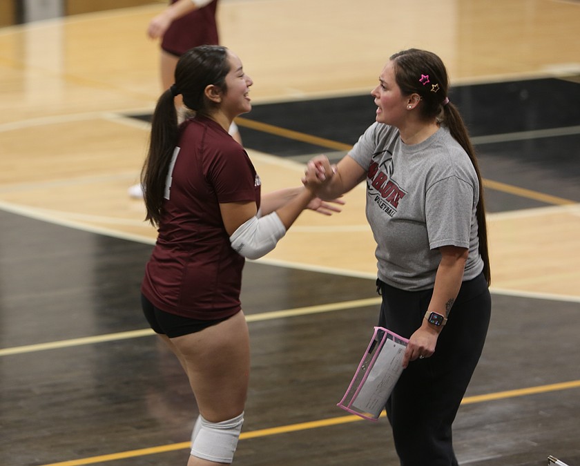 Wahluke Warriors head coach Monica Cortez (right) hypes up Dennys Perez Mendoza (4) during their game against the Royal Knights.