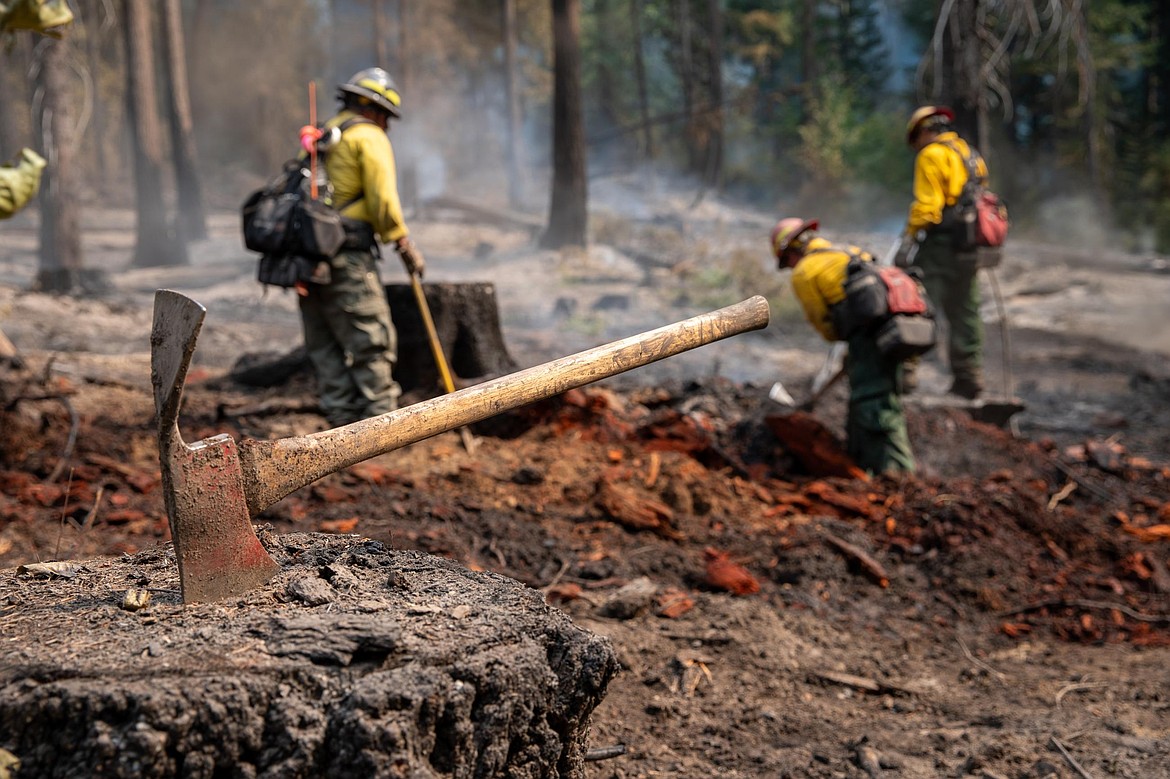 Firefighters work on mopping up the Little Giant Fire, which has scorched around 172,000 acres and is 81% contained as of Sept. 15. This is one of the largest fires still left on the urban wildland interface with a cost estimated at $185 million.