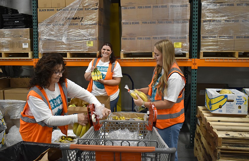 From left: Mary Garza, Rachel Buckle and Pieper Hansen bag bananas at the Moses Lake Food Bank as part of Horizon Credit Union’s annual volunteer day Tuesday.
