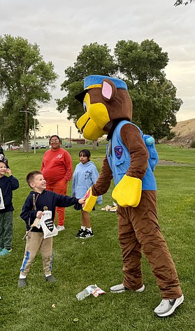 A child high fives Chase at Ephrata’s National Night Out Tuesday. The department served over 100 hot dogs to community members during their first National Night Out.