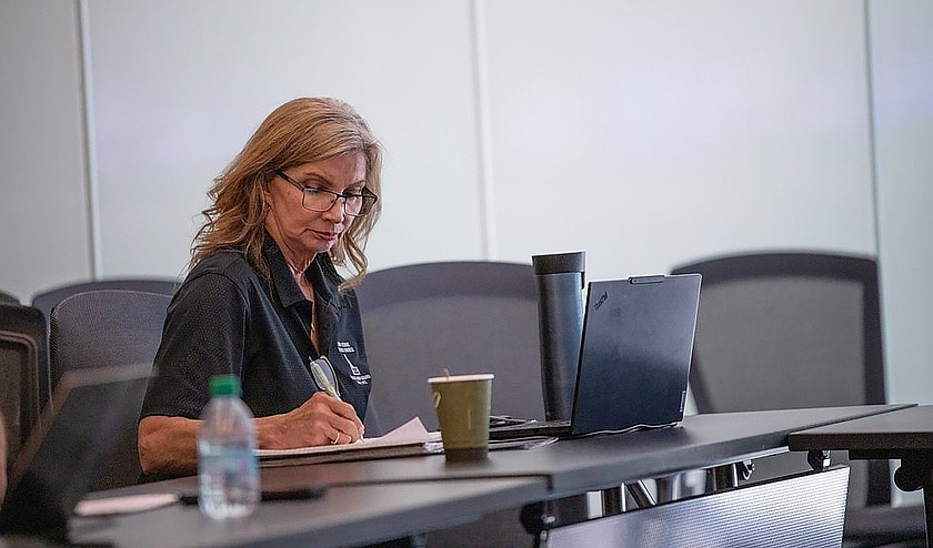 Debbie Hainke, benefits manager for the Idaho School Benefit Trust, takes notes during an Idaho School District Council board meeting on Monday, Aug. 3  in Boise.