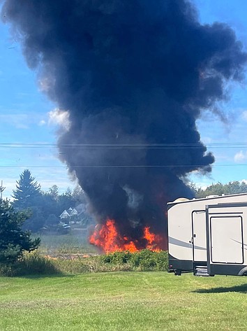 Smoke rises after an F-16 fighter jet crashed in a rural area near Traverse City, Mich., Thursday, Sept. 17, 2026. (Rebecca Lamberson via AP)