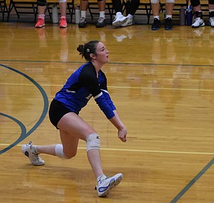 Brittney Cole, a senior from the Cougars, digs in to bump up the ball during the home game against Highland Thursday evening.