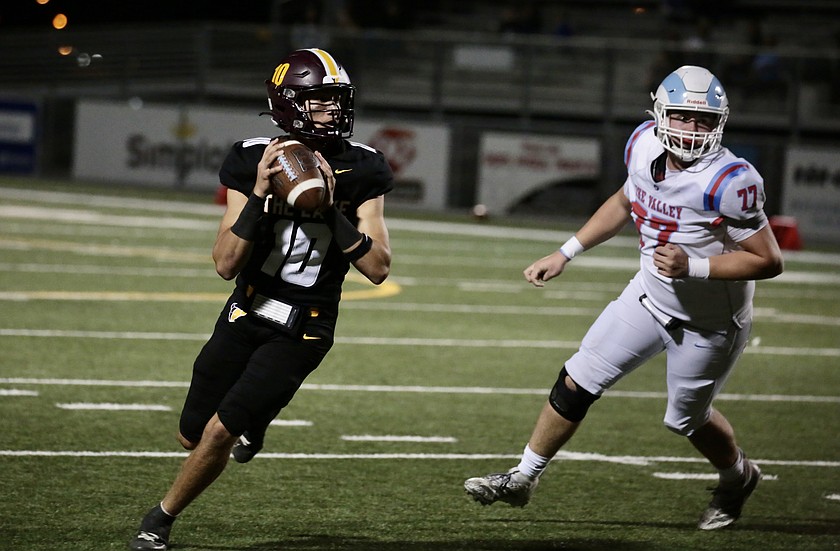 With a West Valley defender on his heels, Mavs quarterback Nolan Decubber looks downfield as he escapes the pocket on Friday.