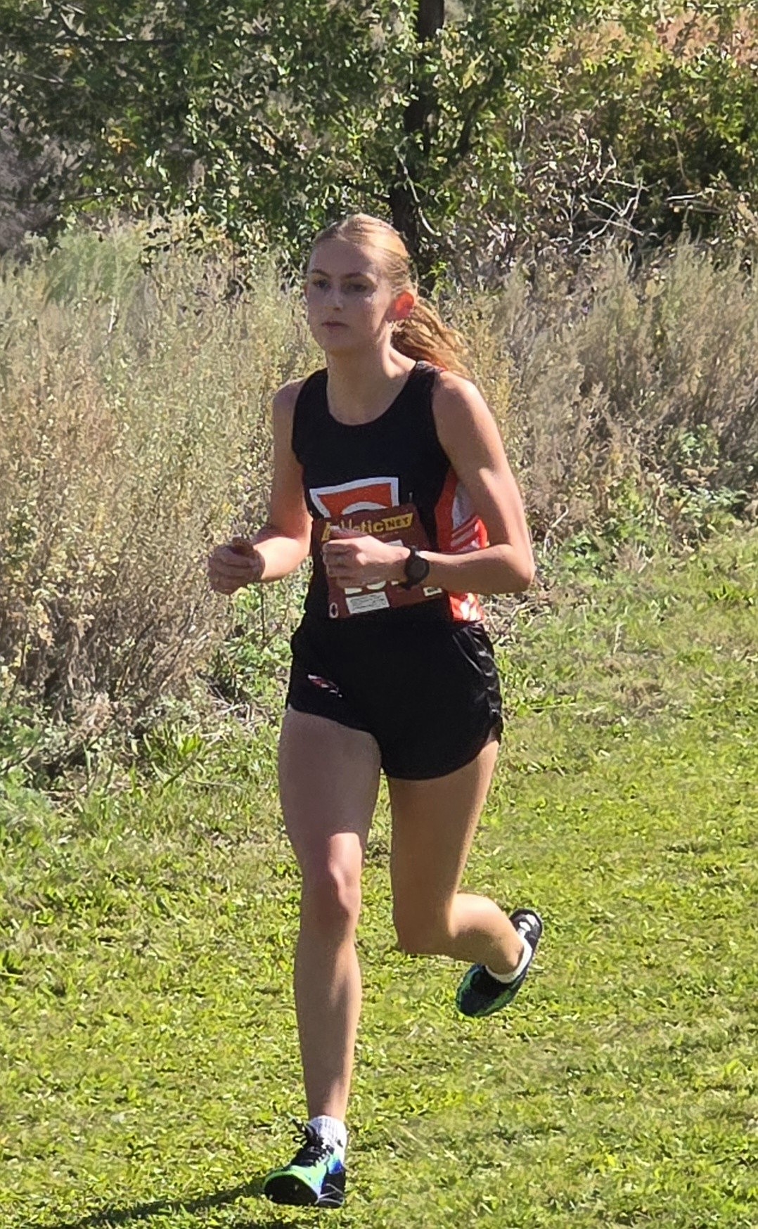 Abigail Chamberlain, a senior from the Tigers carries her pace in the Figure 8 course at Apple Ridge to claim a first-place finish.