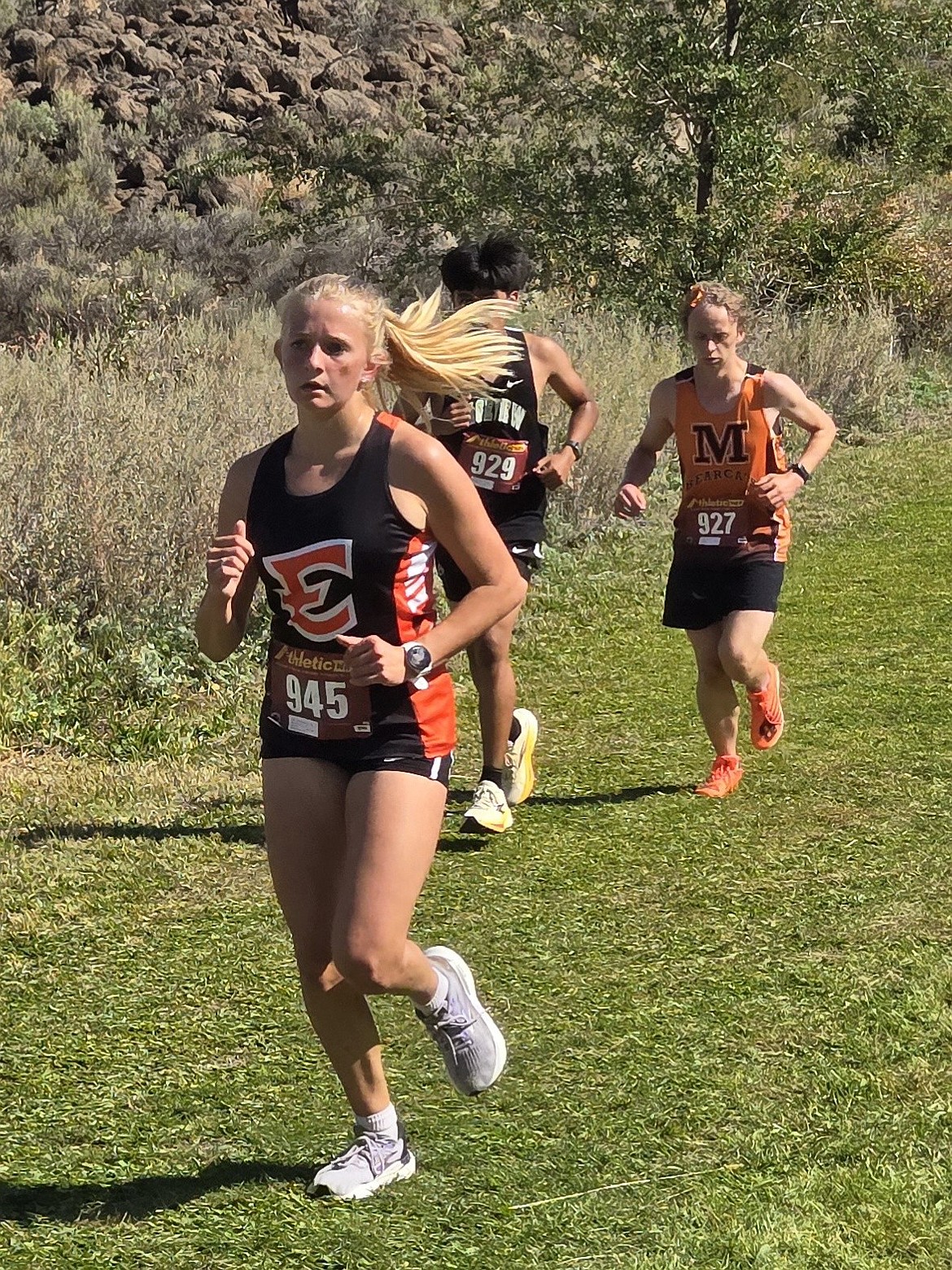 Rebecca Wiser, a junior from Ephrata runs along the track as she makes her way in for a third place finish in the Orchard Loop.