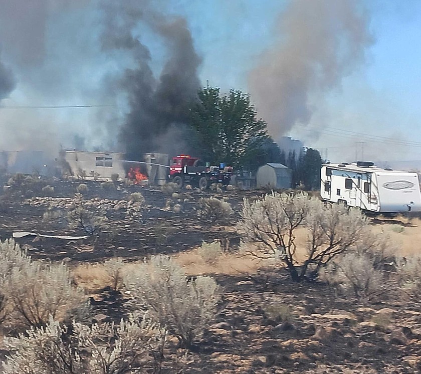 Grant County Fire District 13 firefighters extinguish a wildfire in 2023. Despite the increase in wildfires in recent years, Moses Lake insurance agent Chris Arnberg said homeowners shouldn’t worry about insurance premiums skyrocketing.