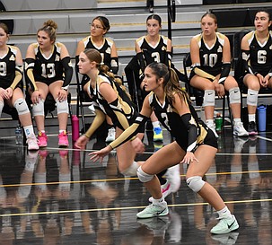 Royal senior Graycie Kast (2) and freshman Mia Thompson (8) get ready for the next serve Tuesday evening against Naches Valley.