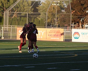 The Mavericks celebrate with Peyton Ross (7) after she scored a goal for the team, putting them up 1-0 over the Selah Vikings Tuesday.