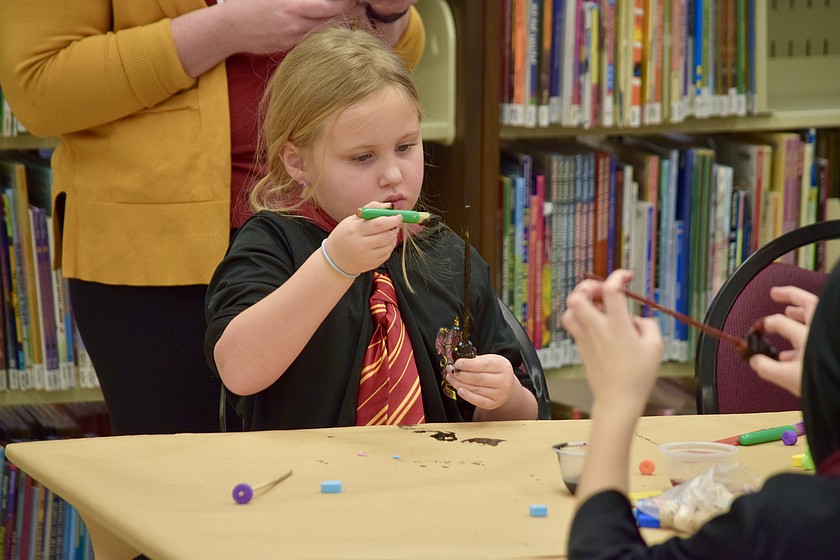 A library patron paints her own magic wand during a craft day at the Moses Lake Public Library. The library building is part of a facility assessment by Moses Lake officials to determine needed upgrades.