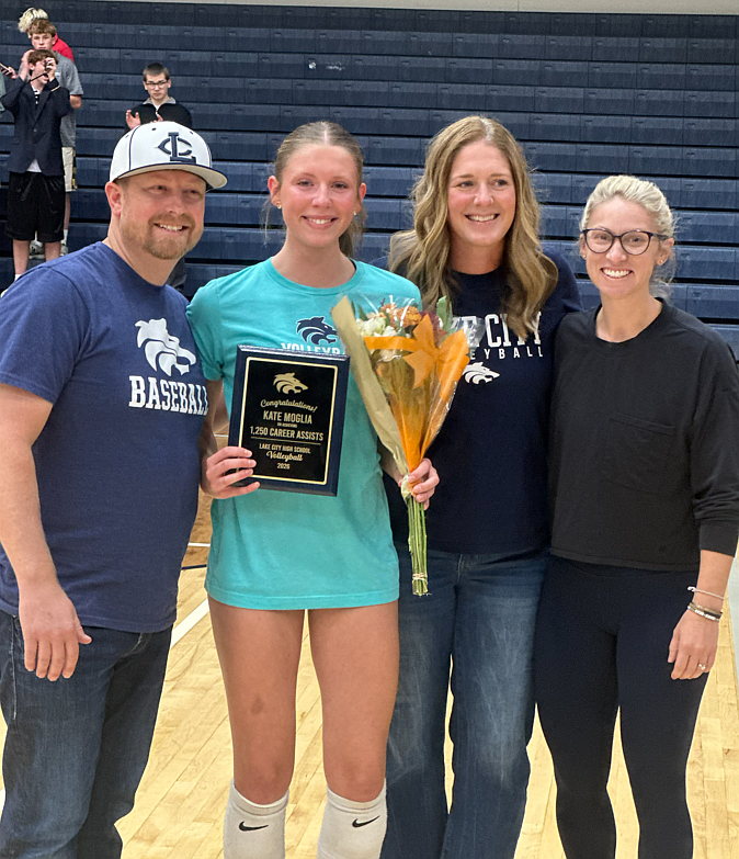 Courtesy photo
After eclipsing the 1,250 mark in career assists Monday vs. Freeman, Lake City senior Kate Moglia was honored prior to Wednesday's match against Coeur d'Alene. From left are Sean Moglia (dad), Kate Moglia, Christy Moglia (mom) and Michelle Kleinberg (Lake City head volleyball coach).