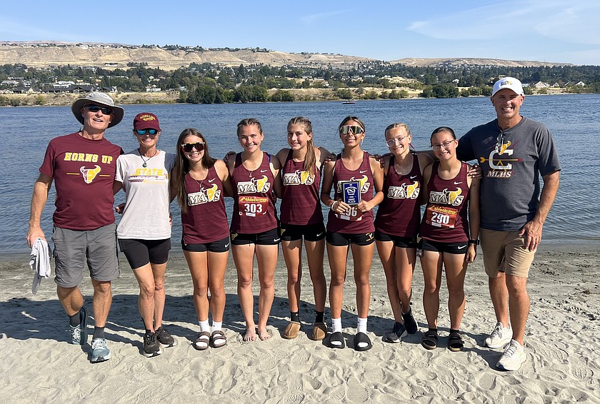 The Mavericks girls varsity squad takes a group photo after a strong performance at the Wenatchee cross country invite Saturday, where the team finished in first place.