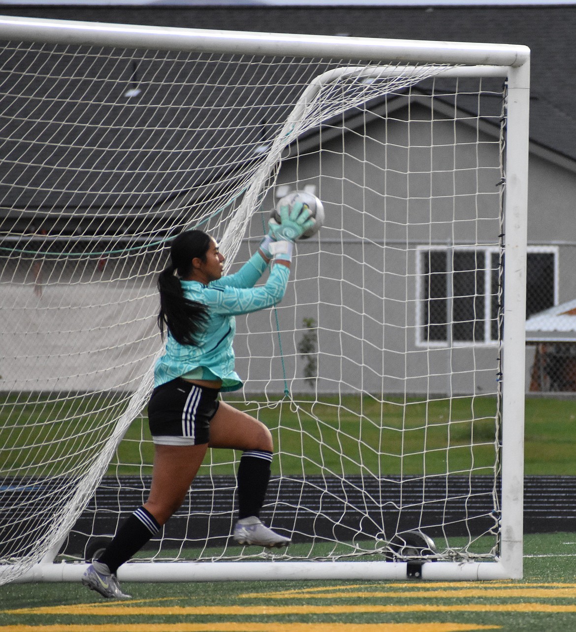 Aylen Garcia, a senior for Quincy, catches the ball to stop an attempt by Othello Thursday evening.