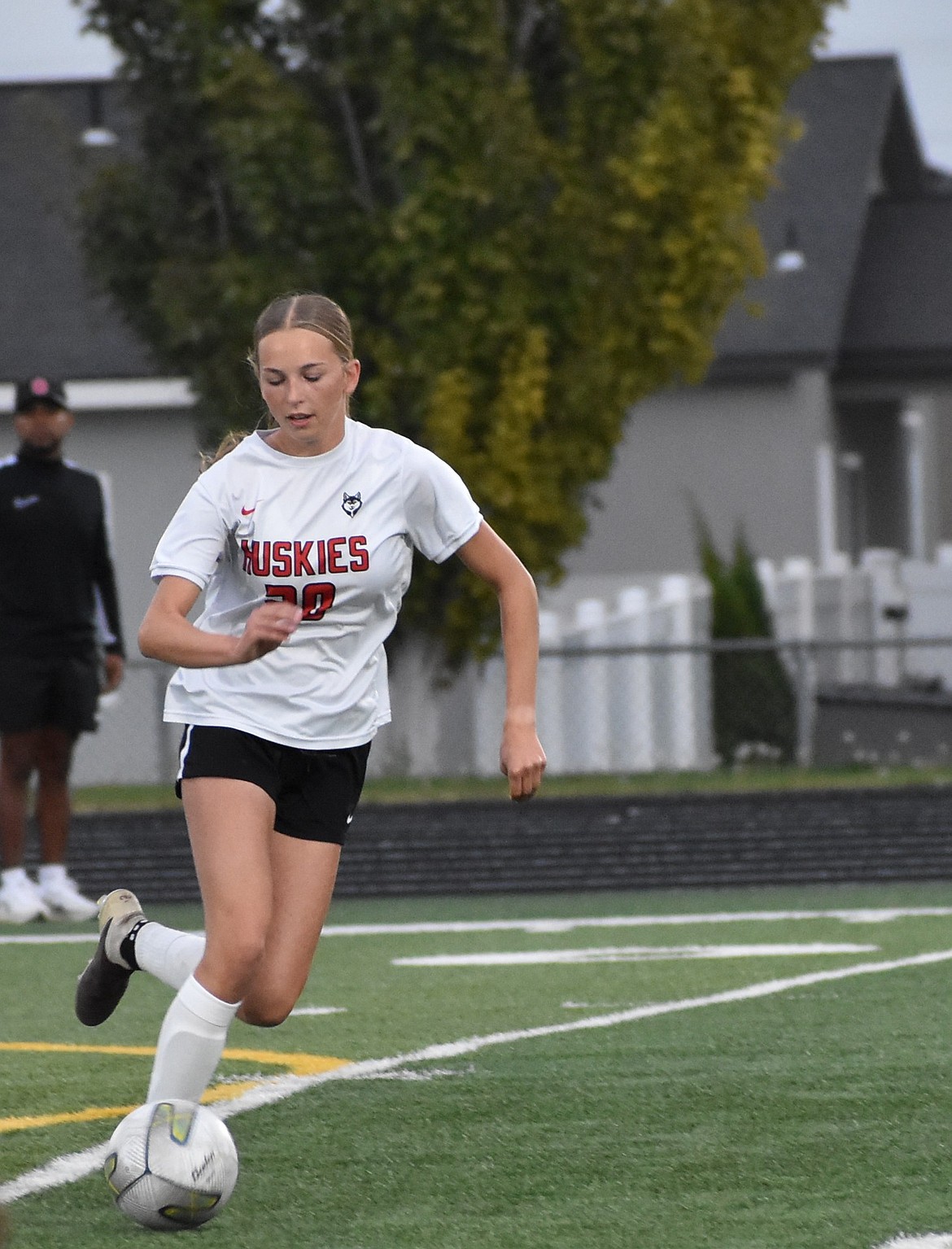 Othello junior Autumn Weyns runs with possession of the ball as she works to keep it away from her Quincy opponents.