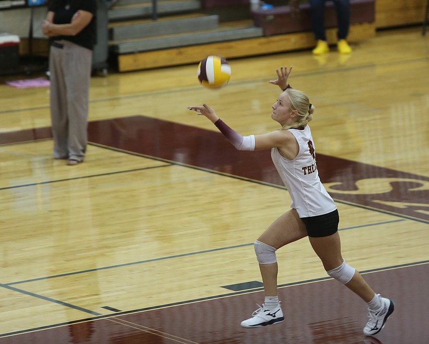 Alivia Dehoog (4) from the Mavs tosses the ball up for her next serve against Eisenhower Thursday.