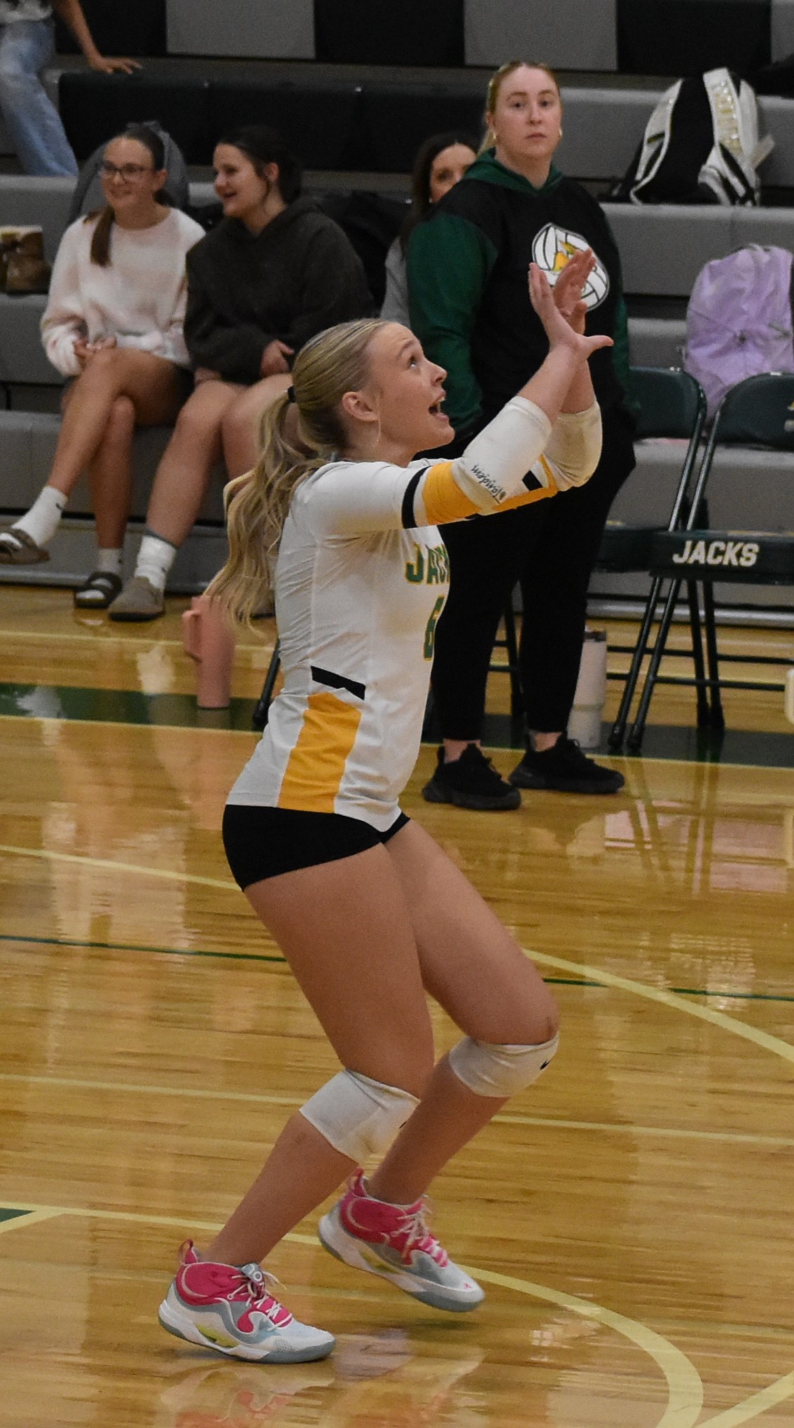 Emma DeTray, a junior from the Jacks, prepares to set the ball for her teammates against the Huskies Thursday.
