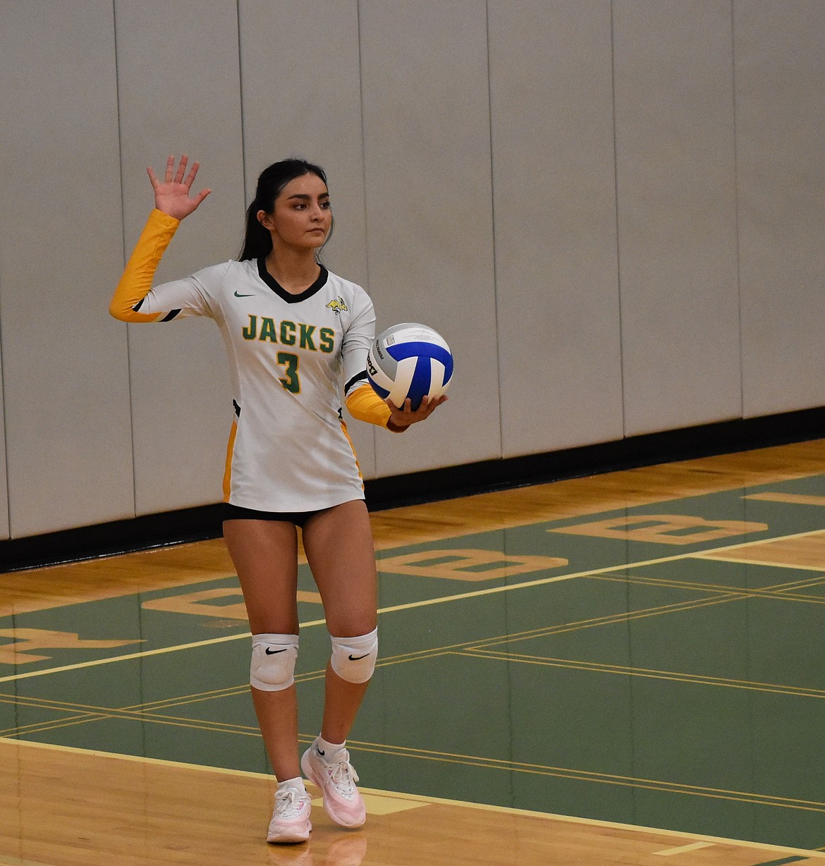 Quincy senior Valeria Navarro steps up to serve against Othello during Thursday's home game.