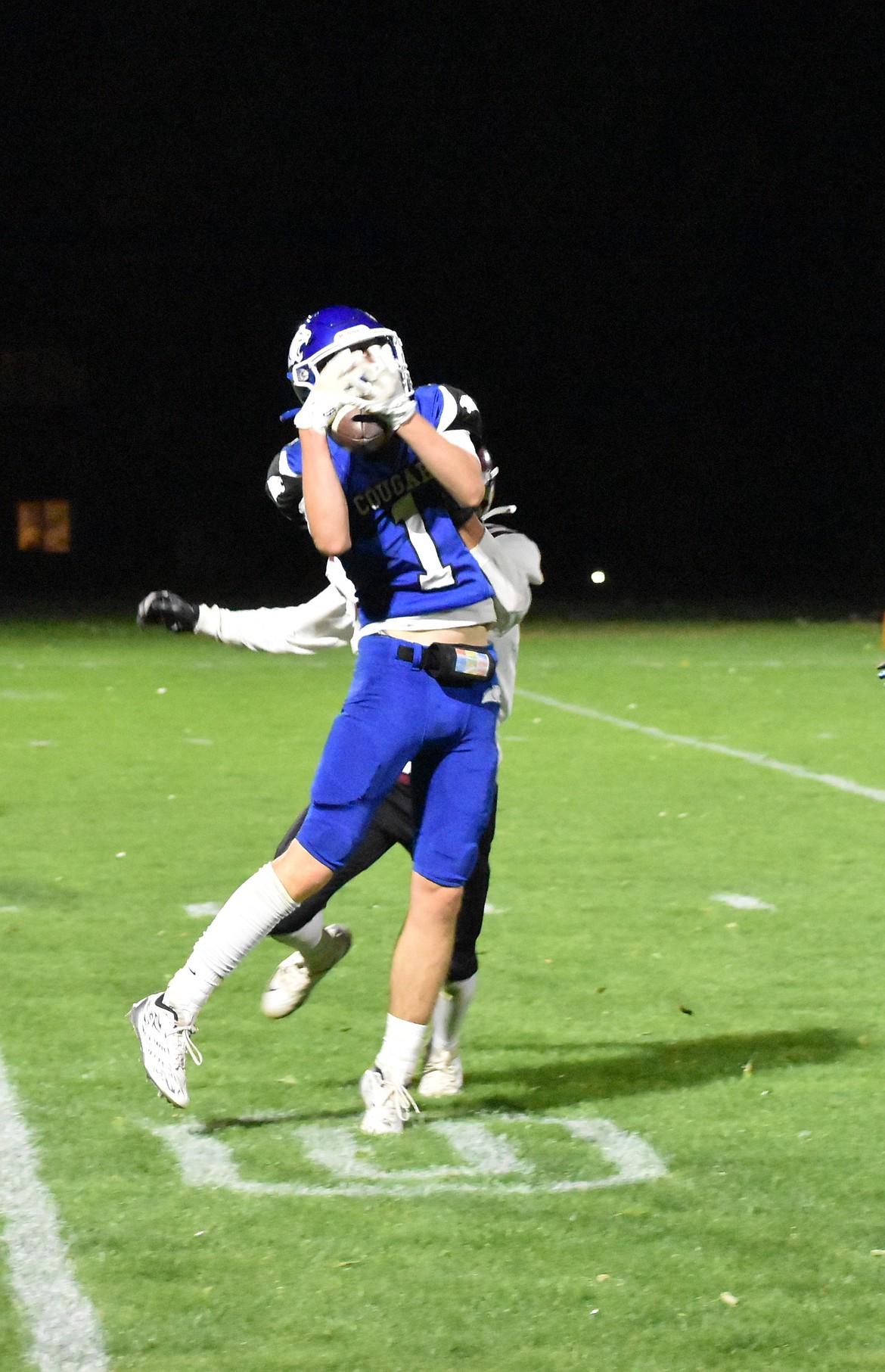 Warden junior JJ Madsen completes a catch near the 30-yard line for a first down and more Thursday at the Cougars' homecoming game.