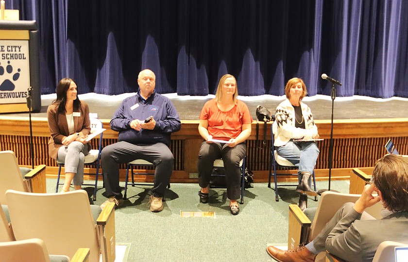 Board members Lisa Aitken, Rick Rasmussen, Heather Tenbrink, and Lesli Bjerke at the public forum at the Lake City High School auditorium.