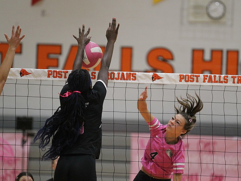 MARK NELKE/Press
Post Falls senior Reese DeGraw hits against the block of Coeur d'Alene senior Jovie Le in the Volleyball 4 the Cure match Tuesday night at The Arena at Post Falls.