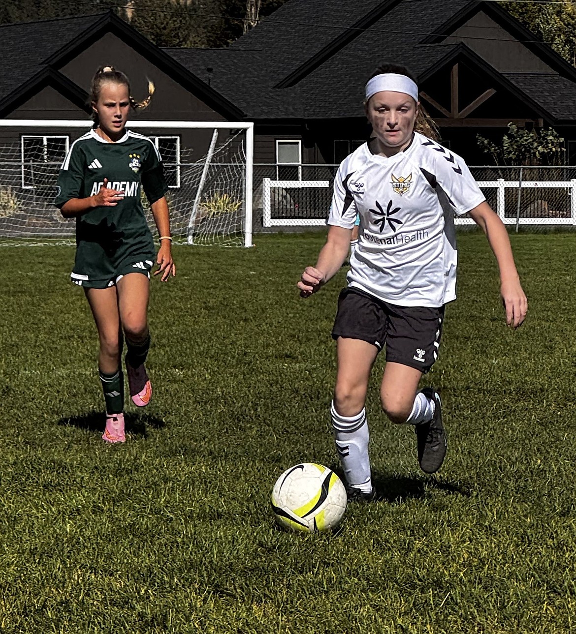 Photo by HAYLEY GABRIEL
Makena Malone, right, of the Sting SC U11 Girls Pre-Academy soccer team brings the ball upfield in a 2-1 loss to the Central Washington Sounders.