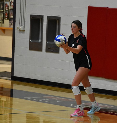 Evelyn Prows, a junior for Othello, gets ready to serve the ball during Tuesday's home game against Selah.