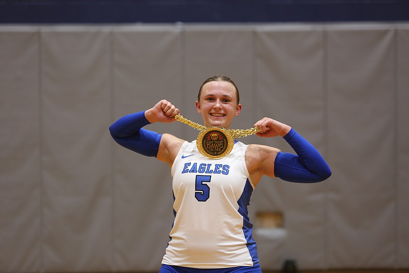 Janessa Knudsen (5) holds up her "dawg of the game" chain after the Soap Lake Eagles defeated the Oroville Hornets 3-0 Tuesday.
