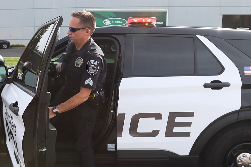 Sgt. Jared Reneau, of the Coeur d'Alene Police Department, exits his patrol vehicle on Thursday.