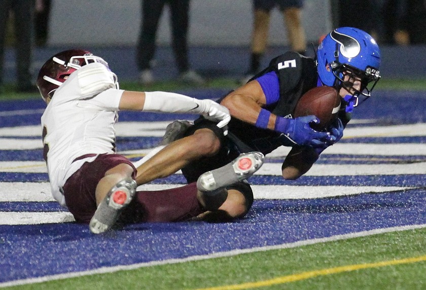 MARK NELKE/Press
Coeur d'Alene senior Gibson Comstock (5) steps in front of Rigby senior Statton Butikofer (6) for the interception late in the first half Thursday night at Viking Field.