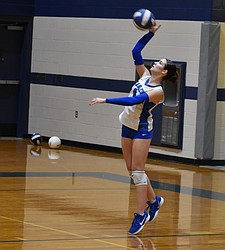 Lily Gonzalez from the Eagles serves the ball to the opposing Devils players during Thursday’s game.