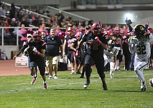 The Huskies’ Aiden Valdez (72) sets a lead block for Cain Gonzalez (7) on his way to the endzone. Othello was victorious 41-6 over the Quincy Jacks Friday.